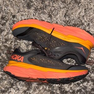 Hoka Black and Vibrant Orange Athletic Shoes